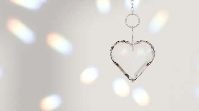 The crystal heart turning in the light, scattering rainbows